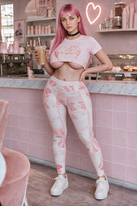 Ahegao anime print leggings and pink drip heart crop top in a pastel pink cafe