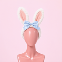 Hop Off bunny ear headband, front view on a mannequin, white faux fur ears with blue satin bow