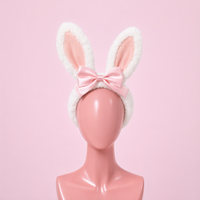 Hop Off bunny ear headband, front view on a mannequin, white faux fur ears with pink satin bow