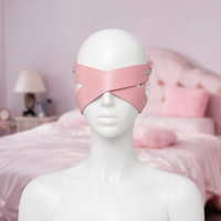Blind Date cross strap eye mask in pink, front view on a mannequin, two straps crossing over the eyes