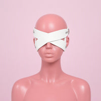 Blind Date white cross strap eye mask, front view on a mannequin, two wide straps crossing in an X