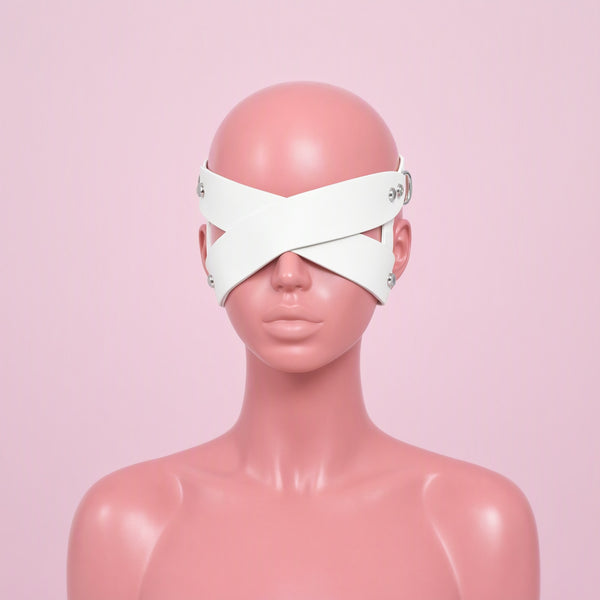 Blind Date white cross strap eye mask, front view on a mannequin, two wide straps crossing in an X