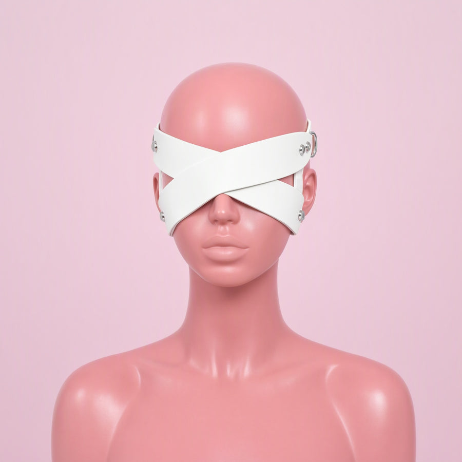 Blind Date white cross strap eye mask, front view on a mannequin, two wide straps crossing in an X