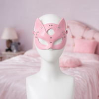 Trickster Fox mask, front view on a mannequin, pink faux leather with pointed ears and almond eye holes