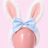 Hop Off bunny ear headband, close-up of the pale pink inner ears and blue satin bow