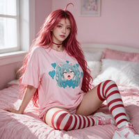 VSCO Catgirl pink oversized shirt — seated on a pink bed with striped thigh highs
