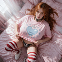 Lying back on pink satin sheets, lifting the hem of the pink Frosted Heart shirt