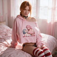 Spit In My Mouth Pink Crop Hoodie — Collection Edition — seated with the shoulder pulled down