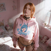Mika in window light wearing the pink crop hoodie, daylight across the print