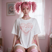 Pastel Goth Heart Side Peek Top — seated front on in soft window light