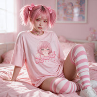 Sitting back on a pink bed in the pink oversized shirt with striped thigh high socks