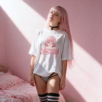 Window light across the white oversized shirt and the busty anime girl print