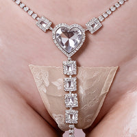 Close up of the clear crystal heart pendant with square crystals on the silver rhinestone g string