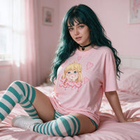 Yandere Crashout Pink Oversized Shirt — seated on pink bedding, the print on show